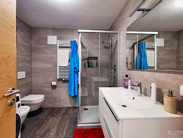 bathroom with shower and washing machine connection