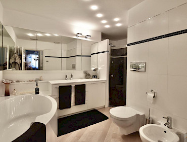 bathroom with bathtub and shower